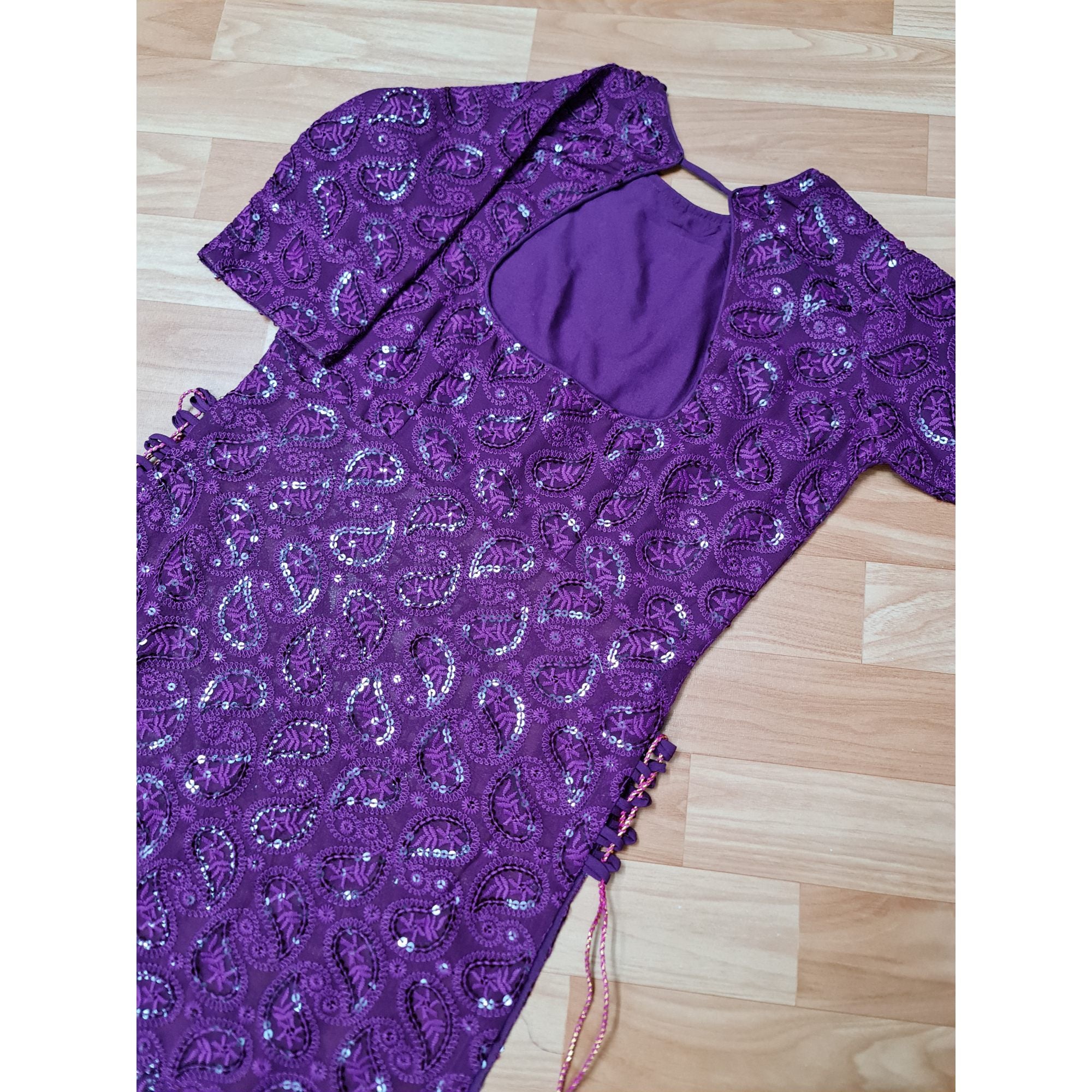 A stunning long kurta in a captivating shade of purple, adorned with intricate Chikankari embroidery and stylish side tassels.