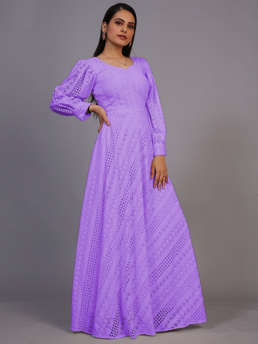 A stunning floor-length gown in rich purple, adorned with intricate Lucknowi embroidery.