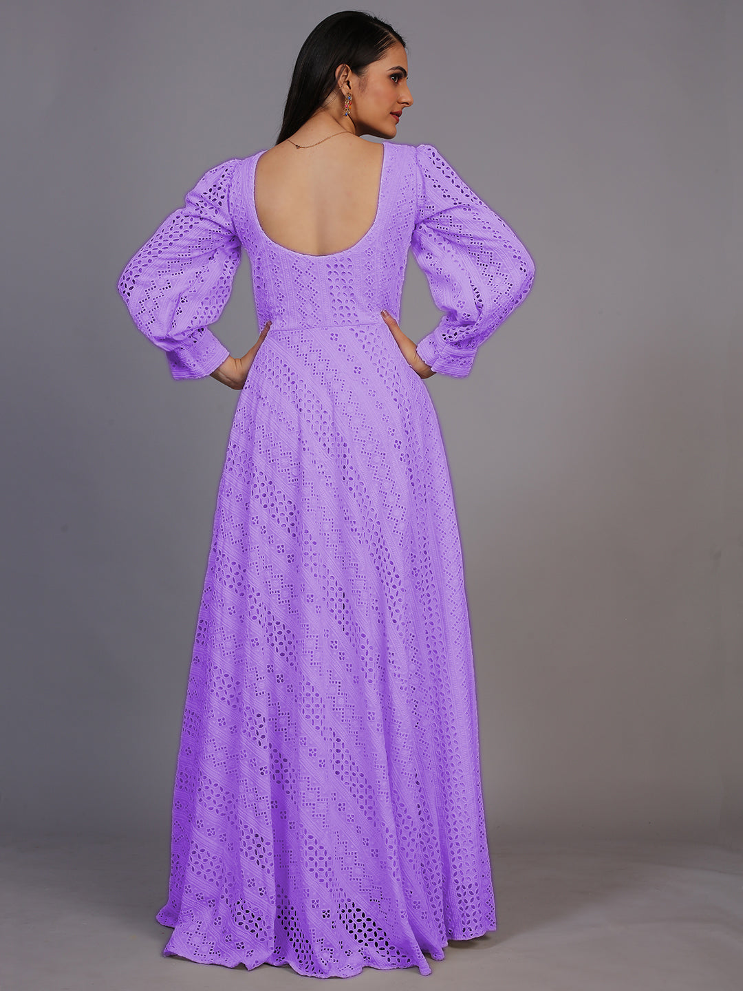 A stunning floor-length gown in rich purple, adorned with intricate Lucknowi embroidery.