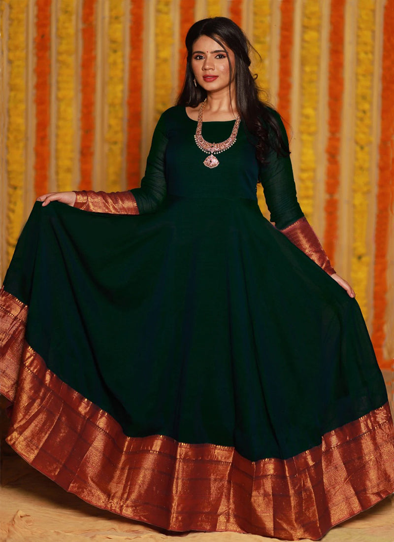 Elegant dark green party wear woven georgette gown offering a refreshing and sophisticated look for special occasions.