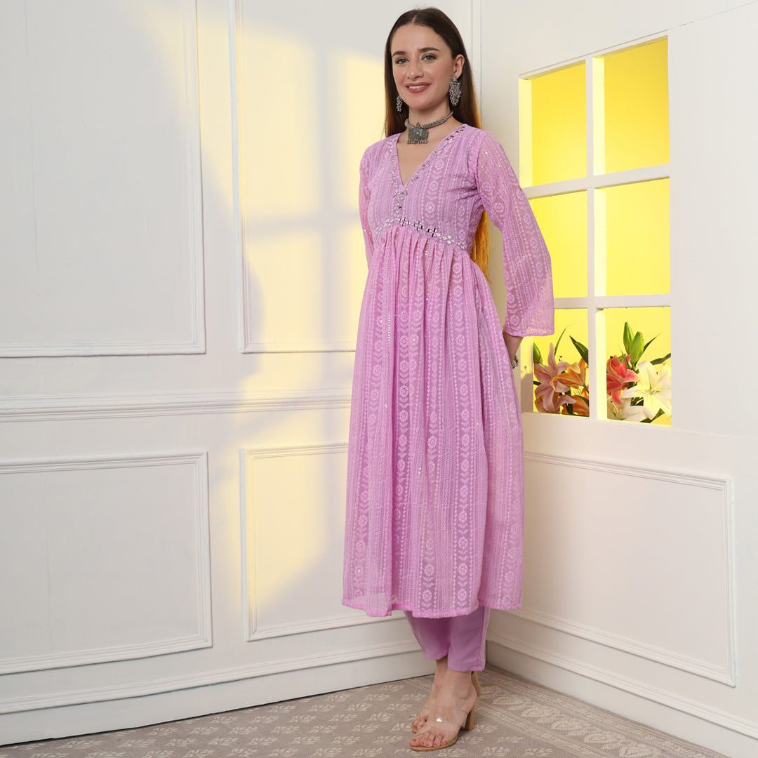 "An enchanting floral mirror work kurta set, harmonizing blooms and sparkling details."