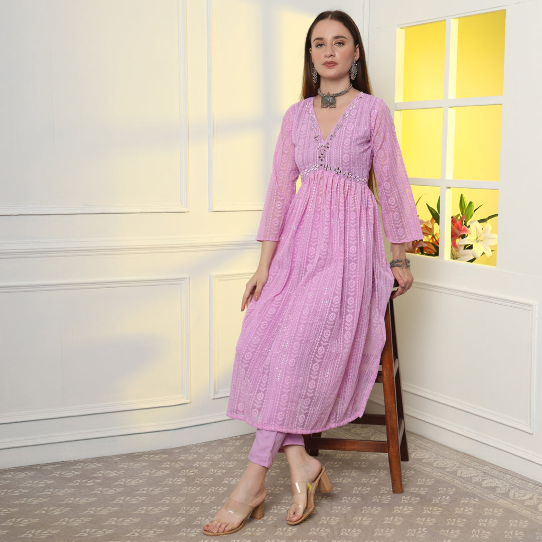 "An enchanting floral mirror work kurta set, harmonizing blooms and sparkling details."