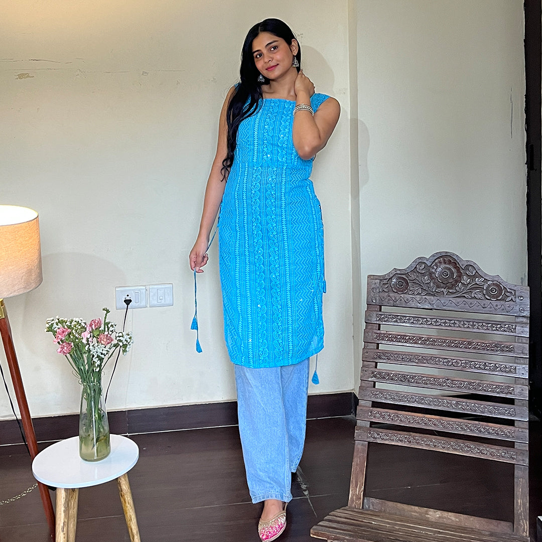 A captivating turquoise georgette kurta adorned with exquisite chikankari embroidery and charming side tassels, exuding elegance and timeless beauty.