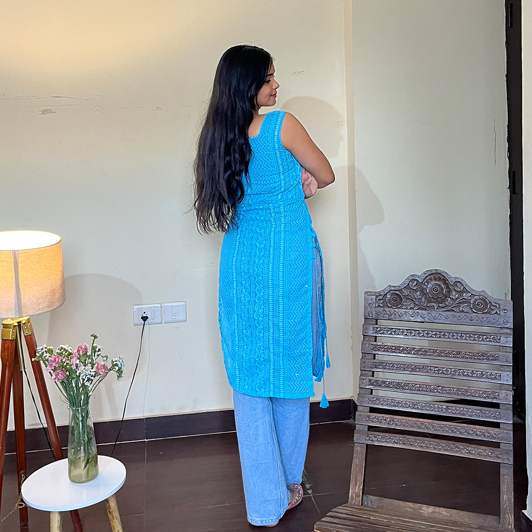 A captivating turquoise georgette kurta adorned with exquisite chikankari embroidery and charming side tassels, exuding elegance and timeless beauty.