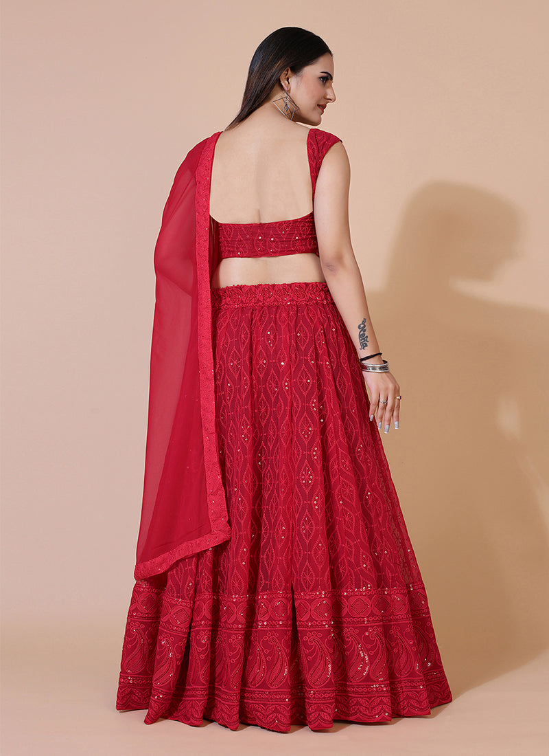 Red A-line Lucknowi Chikankari work stitched lehenga choli, ideal for traditional and festive celebrations with intricate embroidery.